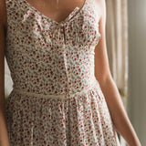 Woman wearing a floral dress with a neutral background
