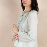 Model wearing mint colored long sleeve top