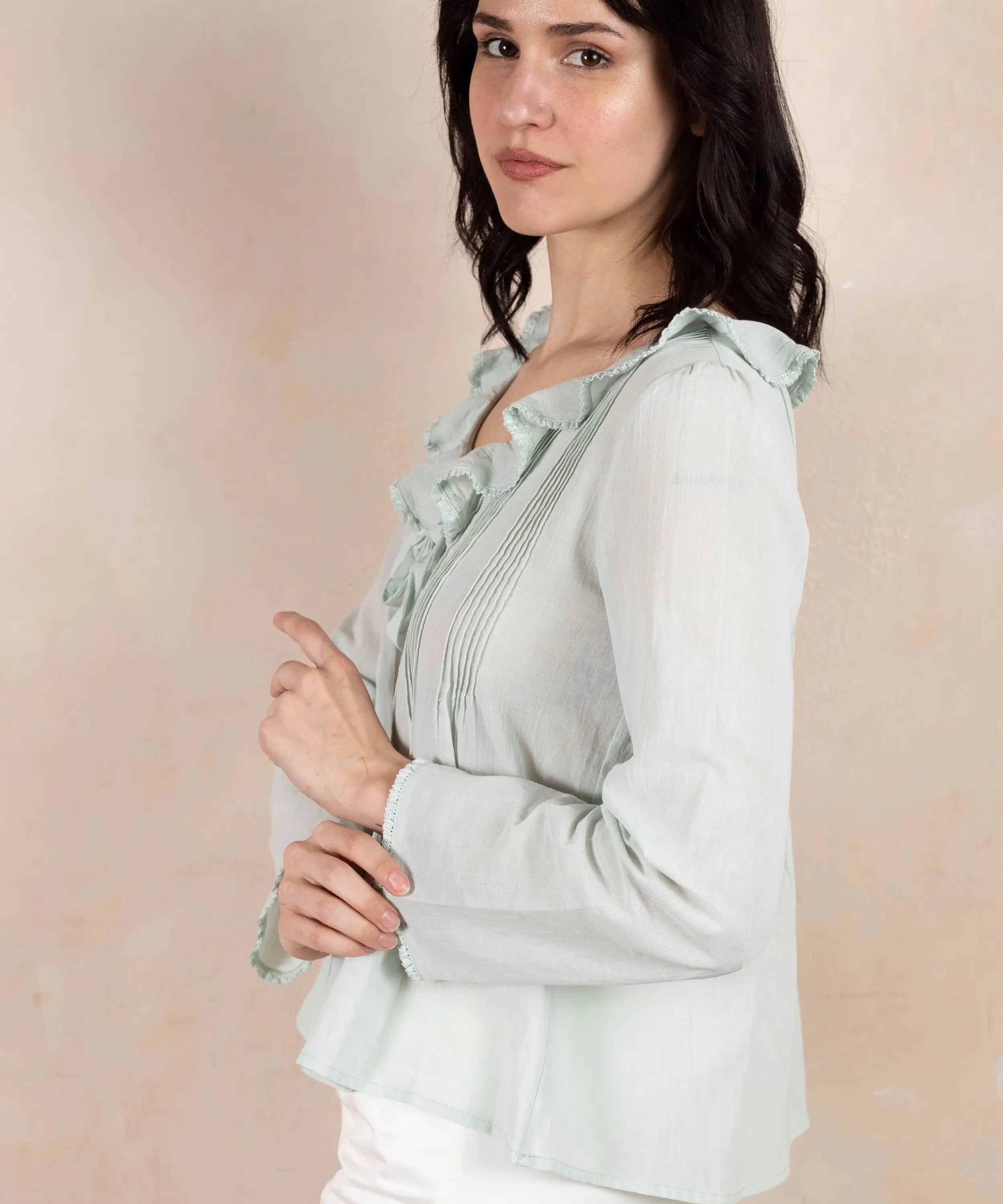 Model wearing mint colored long sleeve top