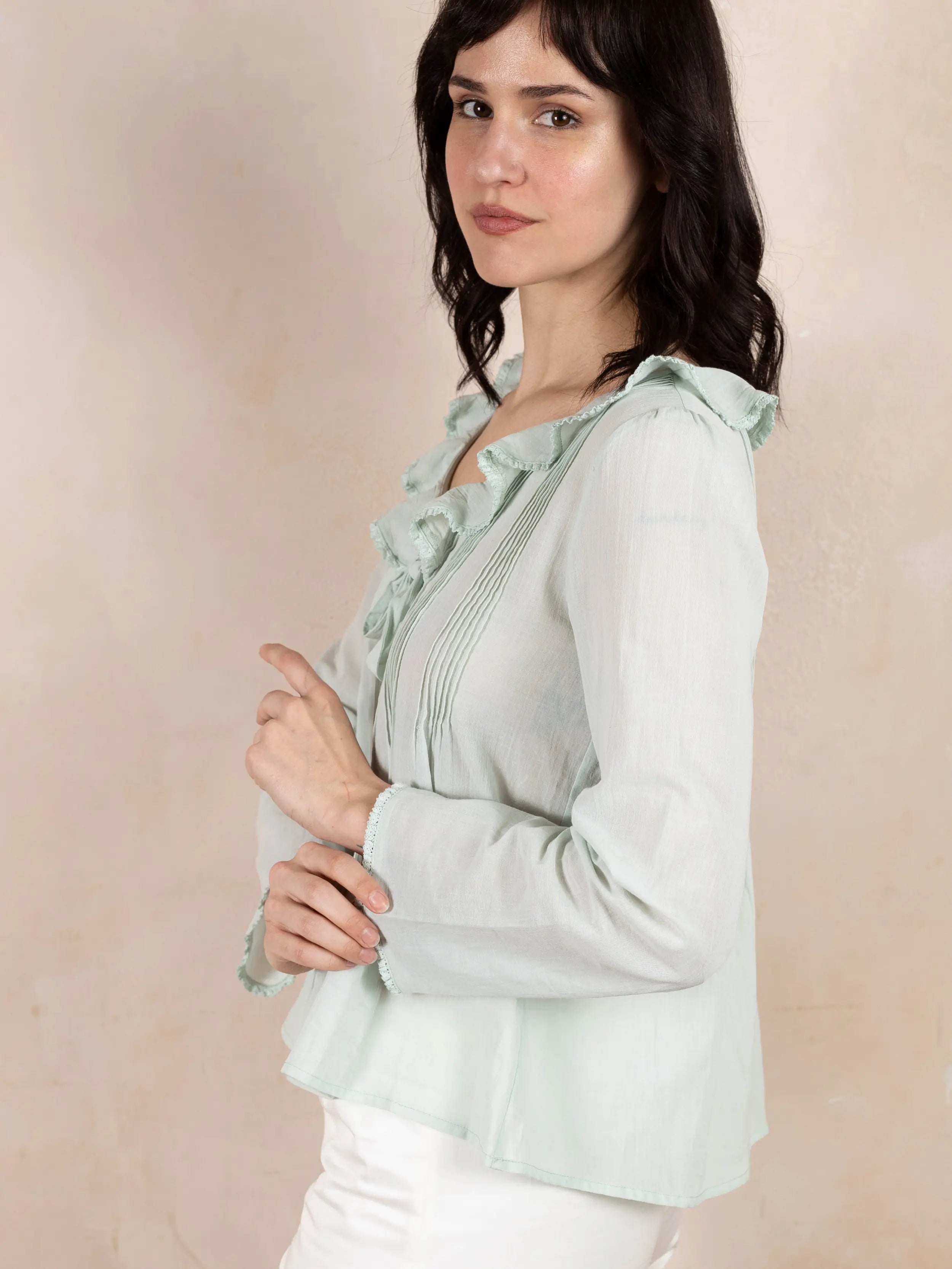 Model wearing mint colored long sleeve top