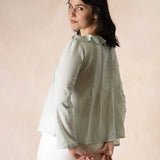 Model wearing mint colored long sleeve top