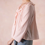 Woman wearing a pink blouse