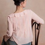 Woman wearing a pink blouse