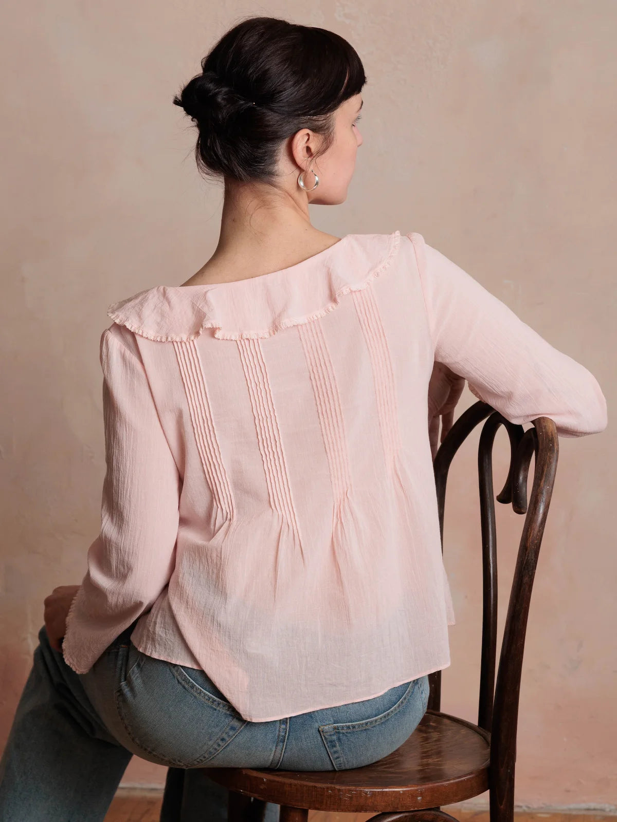 Woman wearing a pink blouse