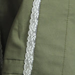 Close-up of green fabric with white lace trim