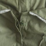 Close-up of a green shirt with lace trim on the collar.